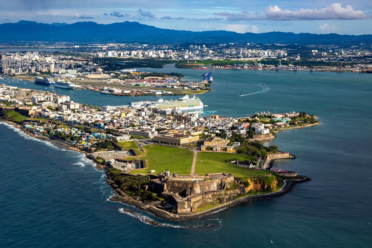 Charter yacht passing Old San Juan historic waterfront